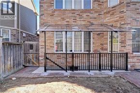 Cambridge apartment for rent - A brick house with a black metal fence.