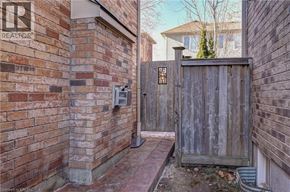 Cambridge apartment for rent - A wooden gate blocks the entrance to a brick building.