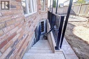Cambridge apartment for rent - A brick wall with a window and a staircase leading to a basement.