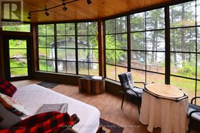 Whitestone apartment for rent - A bedroom with a large bed and a view of the backyard.