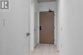 Toronto (Kensington-Chinatown) condo for rent - A brown door is in a white hallway.