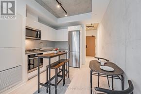 Toronto (Kensington-Chinatown) condo for rent - A modern kitchen with a dining table and chairs.
