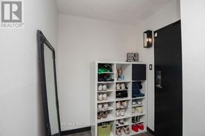Kitchener condo for rent - A shoe rack with multiple pairs of shoes in a white room.