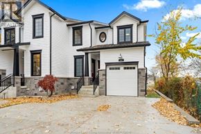 Amherstburg apartment for rent - A white house with a black roof and a sign that says REALTOR.