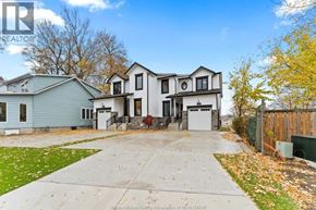 Amherstburg apartment for rent - A house with a blue house in front and a white house in the back.