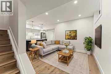 Amherstburg apartment for rent - A living room with a couch, a coffee table, and a painting on the wall.