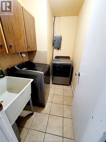 Windsor duplex for rent - A small kitchen with a sink, stove and a dishwasher.