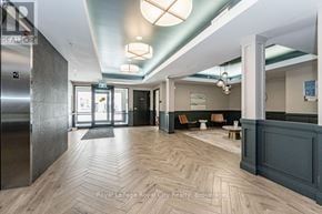 Waterloo condo for rent - A hallway with a wooden floor and a bench with chairs in the background.