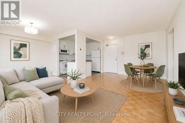 Toronto (University) condo for rent - A living room with a couch, a coffee table, and a dining table.