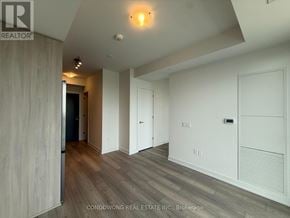 Toronto (Newtonbrook West) condo for rent - A room with wood flooring and white walls, with a light on the ceiling.