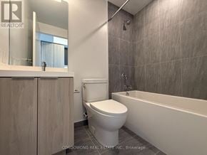 Toronto (Newtonbrook West) condo for rent - A modern bathroom with a toilet, sink, and bathtub.