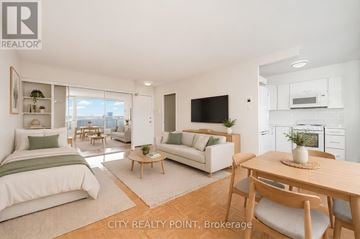 Toronto (University) condo for rent - A well-lit, spacious apartment with a bedroom, living room, and kitchen area.