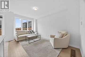 Barrie townhouse for rent - A living room with a white couch and a coffee table.