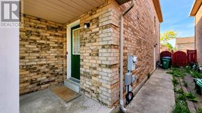 Brampton (Fletcher's Meadow) apartment for rent - A brick house with a green door and a sign that says REALTOR.