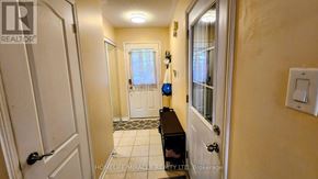 Brampton (Fletcher's Meadow) apartment for rent - A hallway with a bench and a door on the left.