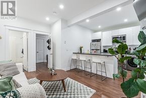 Toronto (Roncesvalles) multi-family for rent - A modern kitchen with white cabinets and a wooden floor.