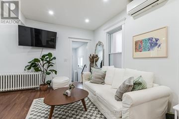 Toronto (Roncesvalles) multi-family for rent - A living room with a white couch and a coffee table.