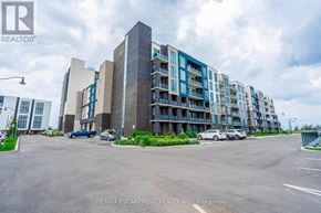 Grimsby (Grimsby Beach) condo for rent - A large building with a parking lot in front of it.