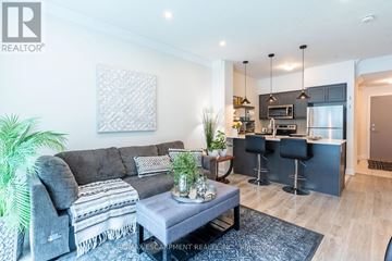 Grimsby (Grimsby Beach) condo for rent - A modern living room with a grey couch and a coffee table.