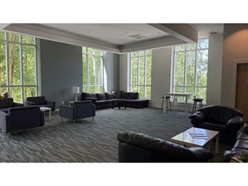 Surrey apartment for rent - A living room with a large couch and a coffee table.