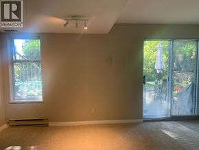 North Vancouver apartment for rent - A room with a window and sliding glass doors leading to a patio.