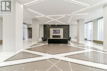 Mississauga (Hurontario) condo for rent - A spacious living room with a central television and a black sofa.