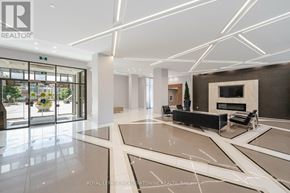Mississauga (Hurontario) condo for rent - A spacious lobby with a marble floor and a large glass door.
