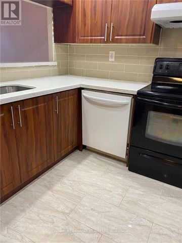 Brampton (Queen Street Corridor) condo for rent - A kitchen with a dishwasher and oven.