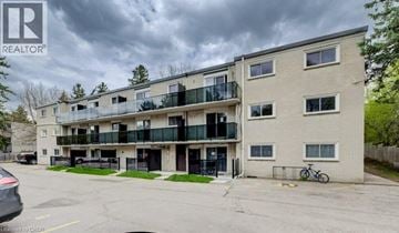Cambridge apartment for rent - A cloudy day at the REALTOR® building with a car parked in front.