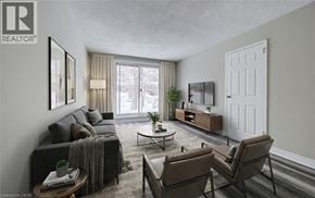 Cambridge apartment for rent - A living room with a grey couch, a coffee table, and a large window.
