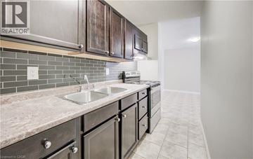 Cambridge apartment for rent - A kitchen with a sink and a stove top oven.