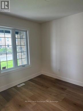 Wellington North (Mount Forest) townhouse for rent - A room with a window and wooden flooring.