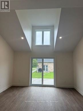 Wellington North (Mount Forest) townhouse for rent - A room with a slanted ceiling and a window.