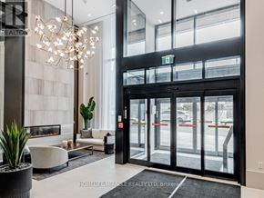 Toronto (Humewood-Cedarvale) condo for rent - A large glass door with a black frame and a sign above it.