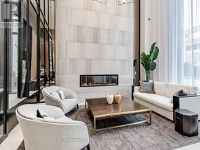 Toronto (Humewood-Cedarvale) condo for rent - A modern living room with a fireplace and a large window.