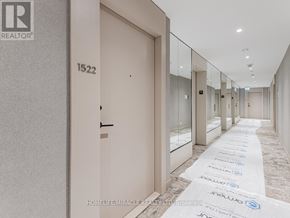 Toronto (Humewood-Cedarvale) condo for rent - A hallway with a white carpet and glass doors.