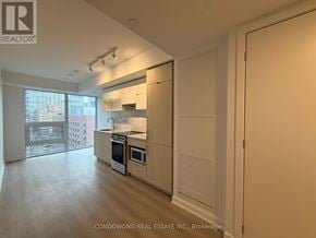 Toronto (Church-Yonge Corridor) condo for rent - A kitchen with white appliances and wooden cabinets.
