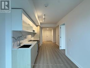 Toronto (Church-Yonge Corridor) condo for rent - A kitchen with white cabinets and a sink.