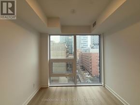 Toronto (Church-Yonge Corridor) condo for rent - A room with a large window overlooking a city street.