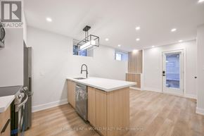 Toronto (Dufferin Grove) apartment for rent - A modern kitchen with wooden cabinets and a white countertop.