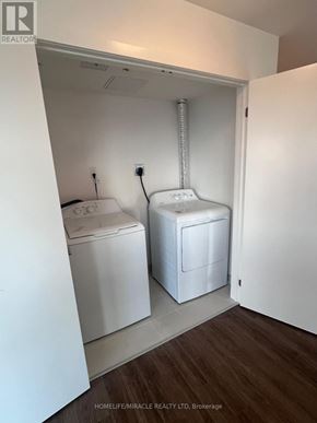 Clarington (Bowmanville) condo for rent - A small laundry room with a washer and dryer.