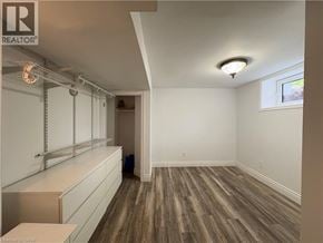 Ancaster apartment for rent - A room with wooden flooring and white walls, with a window on the right wall.