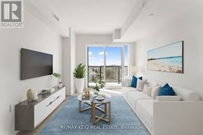 Toronto (Yorkdale-Glen Park) condo for rent - A modern living room with a flat screen TV and a large window overlooking the beach.