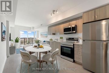 Toronto (Yorkdale-Glen Park) condo for rent - A modern kitchen with stainless steel appliances and a dining table set for four.