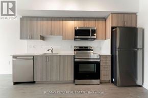 Toronto (Yorkdale-Glen Park) condo for rent - A modern kitchen with a sink, oven, and refrigerator.