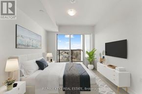 Toronto (Yorkdale-Glen Park) condo for rent - A bedroom with a large bed, a flat screen TV, and a view of the city.