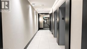Kitchener condo for rent - A long hallway with a sign that says REALTOR.