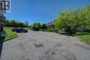 Cambridge apartment for rent - A parking lot with cars and a building in the background.