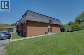 Cambridge apartment for rent - A house with a brown brick exterior and a grey roof is for sale.