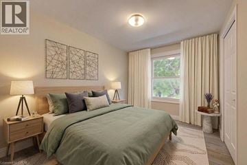 Cambridge townhouse for rent - A bedroom with a large bed and a window with curtains.